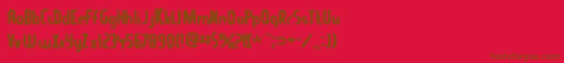 フォントTommygun – 赤い背景に茶色の文字