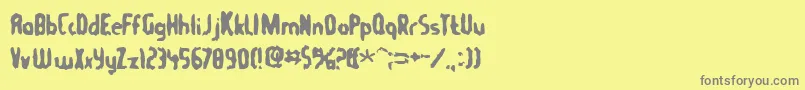 フォントTommygun – 黄色の背景に灰色の文字
