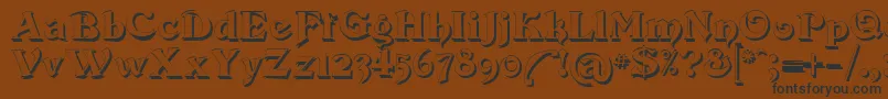 Devinne Swash Shadow Font – Black Fonts on Brown Background