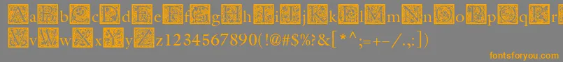 フォントMedievalInitialThree – オレンジの文字は灰色の背景にあります。