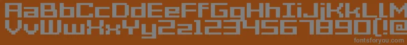 GrixelAcme7WideBold-fontti – harmaat kirjasimet ruskealla taustalla