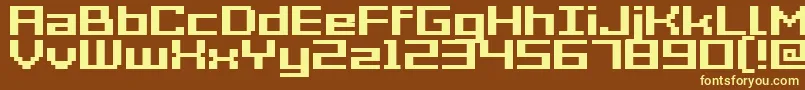 GrixelAcme7WideBold-fontti – keltaiset fontit ruskealla taustalla