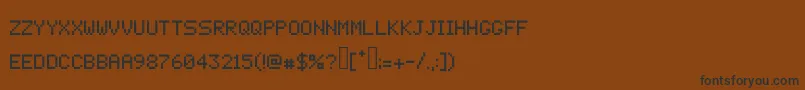 フォントPixelcrypt – 黒い文字が茶色の背景にあります