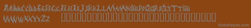Demed-fontti – harmaat kirjasimet ruskealla taustalla