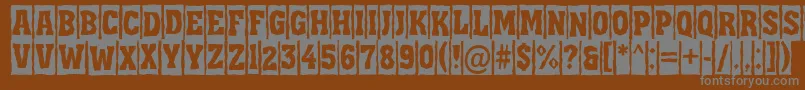 AAssuantitulcmbrk-fontti – harmaat kirjasimet ruskealla taustalla