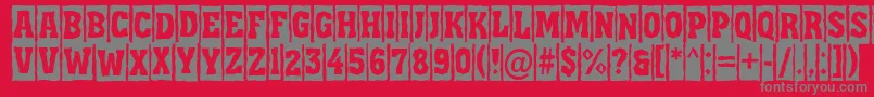 フォントAAssuantitulcmbrk – 赤い背景に灰色の文字