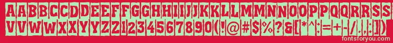 フォントAAssuantitulcmbrk – 赤い背景に緑の文字
