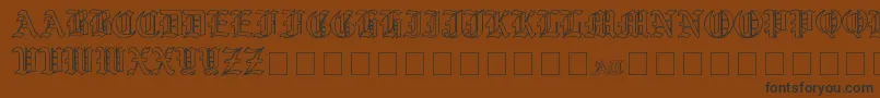 Czcionka YeOldShireOutline – czarne czcionki na brązowym tle