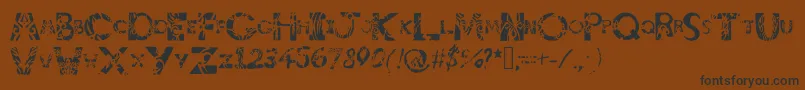 フォントTribalistiktatwu – 黒い文字が茶色の背景にあります