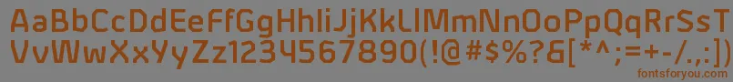 フォントAlphiisbRegular – 茶色の文字が灰色の背景にあります。