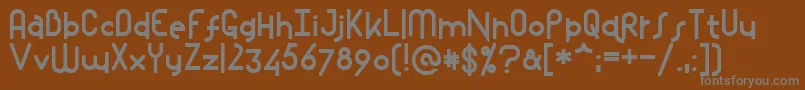 Mostios-fontti – harmaat kirjasimet ruskealla taustalla