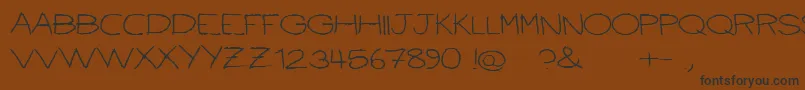 Ballpointscratch Font – Black Fonts on Brown Background