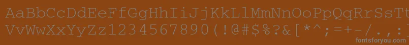 Ukrainiancourier-fontti – harmaat kirjasimet ruskealla taustalla