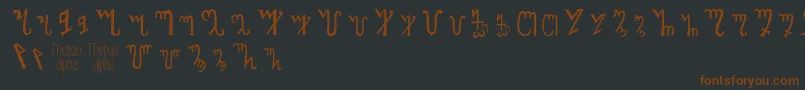 フォントThebanalphabet – 黒い背景に茶色のフォント
