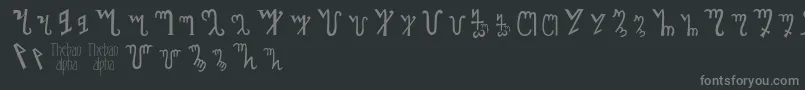 フォントThebanalphabet – 黒い背景に灰色の文字