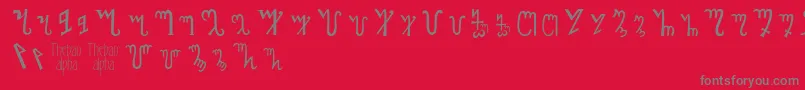 フォントThebanalphabet – 赤い背景に灰色の文字