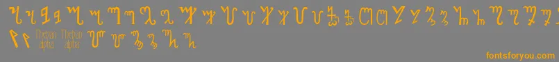 フォントThebanalphabet – オレンジの文字は灰色の背景にあります。