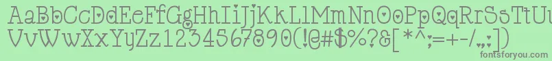 Cupiddelocke-fontti – harmaat kirjasimet vihreällä taustalla
