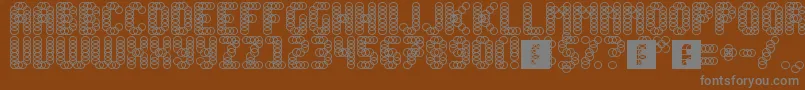 Slink-fontti – harmaat kirjasimet ruskealla taustalla