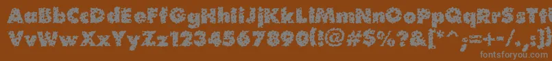 Waterhole-fontti – harmaat kirjasimet ruskealla taustalla