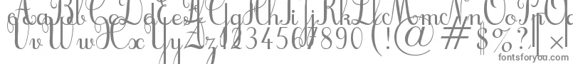 フォントCursif – 白い背景に灰色の文字