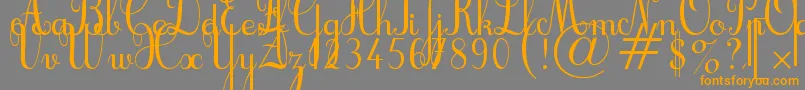 フォントCursif – オレンジの文字は灰色の背景にあります。