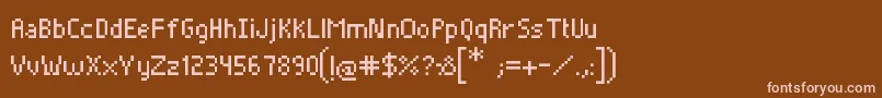 Czcionka Pixelade – różowe czcionki na brązowym tle