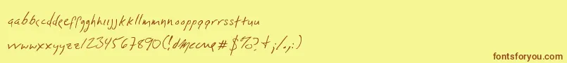 フォントDlylehand – 茶色の文字が黄色の背景にあります。