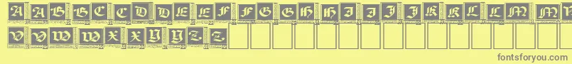 WoodcutCapitals Font – Gray Fonts on Yellow Background