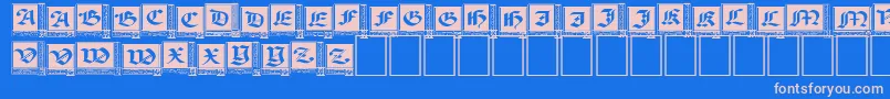 WoodcutCapitals Font – Pink Fonts on Blue Background