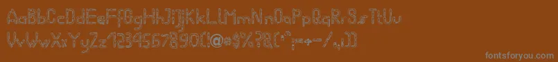 フォントWormBecker – 茶色の背景に灰色の文字