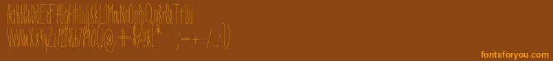 Czcionka DorothyMiranda – pomarańczowe czcionki na brązowym tle