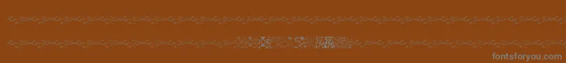 フォントMayaTilesPromo – 茶色の背景に灰色の文字
