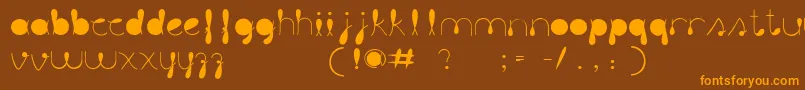 フォントLiquitColour – オレンジ色の文字が茶色の背景にあります。