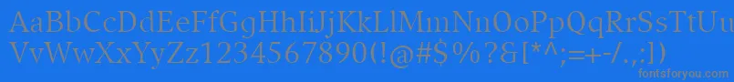 フォントCompatilExquisitLtComRegular – 青い背景に灰色の文字