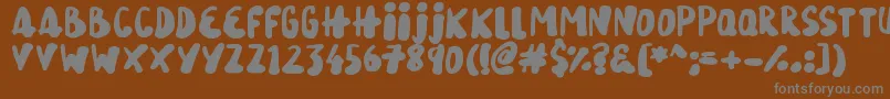 SnowySkies-fontti – harmaat kirjasimet ruskealla taustalla