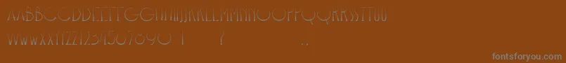 Bangkit-fontti – harmaat kirjasimet ruskealla taustalla