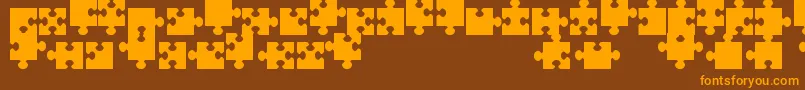JigsawPiecesTfb-Schriftart – Orangefarbene Schriften auf braunem Hintergrund