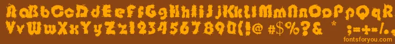 フォントShockfloyd – オレンジ色の文字が茶色の背景にあります。