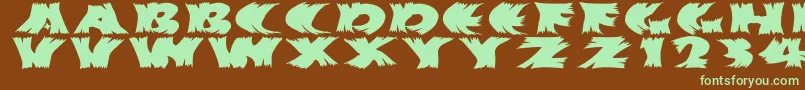 フォントHurrikanish – 緑色の文字が茶色の背景にあります。