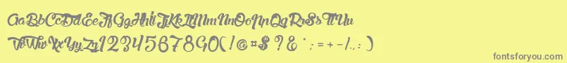 LaChatteAMaman-Schriftart – Graue Schriften auf gelbem Hintergrund
