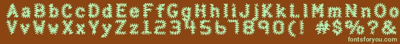 フォントHalterAntigenic – 緑色の文字が茶色の背景にあります。