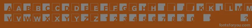 Abclogosxyz-fontti – harmaat kirjasimet ruskealla taustalla
