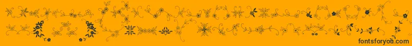 Fonte MeninaGraciosaOrnamentsTwo – fontes pretas em um fundo laranja