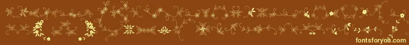 Czcionka MeninaGraciosaOrnamentsTwo – żółte czcionki na brązowym tle