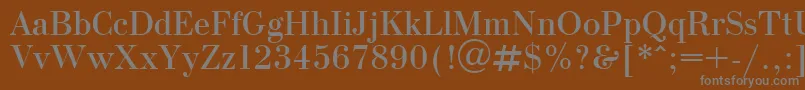 OlgaPlain-fontti – harmaat kirjasimet ruskealla taustalla