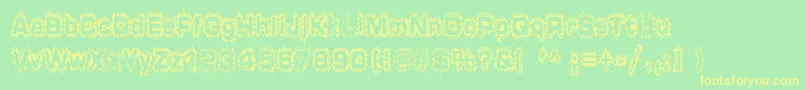 フォントGrungepuddles – 黄色の文字が緑の背景にあります