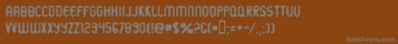 Wildsewe-fontti – harmaat kirjasimet ruskealla taustalla