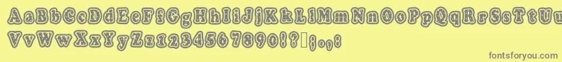 Polkaletterstamp-fontti – harmaat kirjasimet keltaisella taustalla