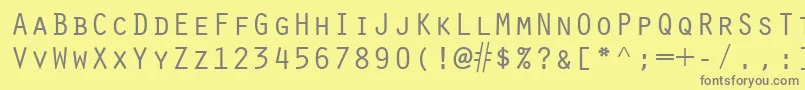 ScribeSsiSmallCaps-fontti – harmaat kirjasimet keltaisella taustalla